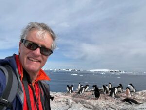 Hugh Rose with pengüins in Antarctica